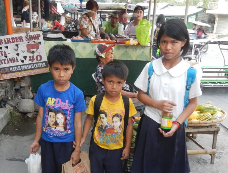 three children in front of a store