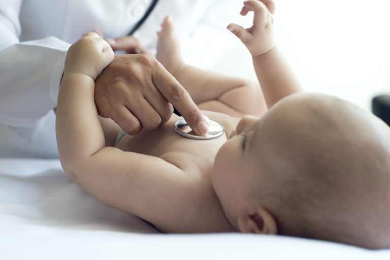 doctor listening to baby's heartbeat