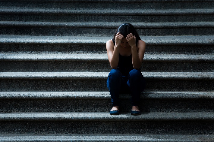 Frustrated young woman on the stairs