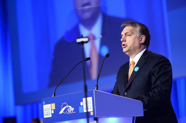 man speaking at podium