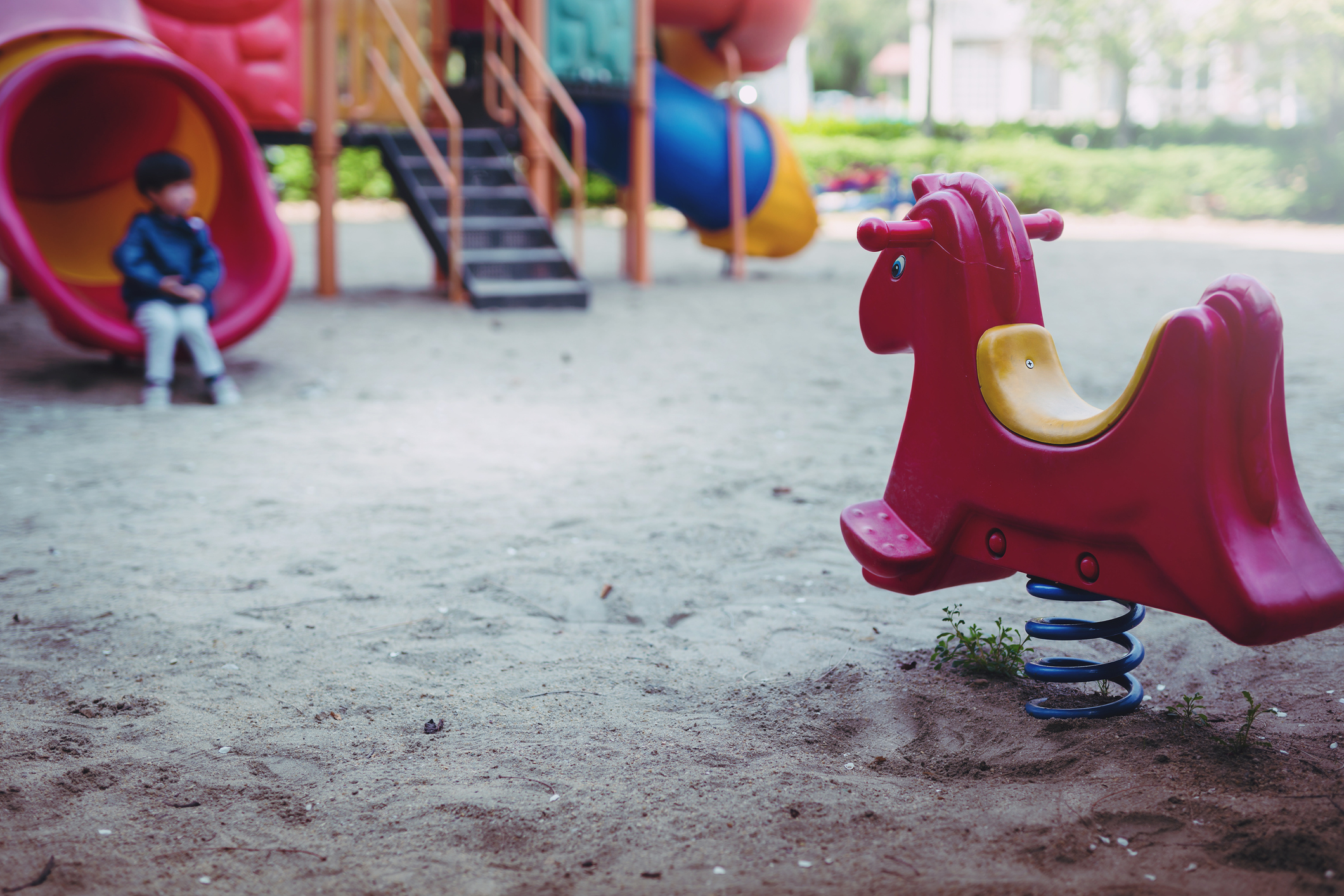 little boy is playing lonely in playground. little boy is sitting unhappy in playground. little boy is playing lonely in playground. little boy is sitting unhappy in playground.